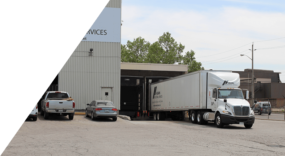 White truck parked at industrial facility